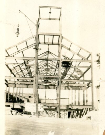 Shown here is the steel-frame structure of the new church erected between the rectory and convent after parishioners determined that a new building should replace the aging chapel. Designed by architect G. C. Freeman of Reading and built under diocesan approval without a general contractor, the project provided both needed economy and employment for parish members during difficult labor conditions. Planned to seat 525 people and constructed with steel framing, hollow tile walls, and a California stucco finish, the church was begun in the spring of 1928 and was under roof by the onset of winter. Photo provided by Dan Eagan.